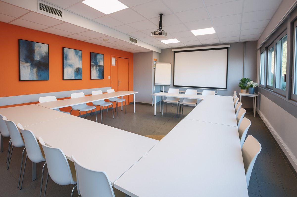 Salle de réunion avec écran de projection et vidéoprojecteur, réunion hybride à Montpellier